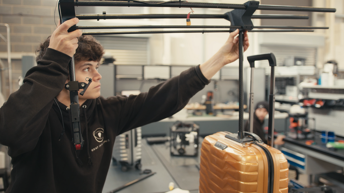 a man holding a piece of luggage