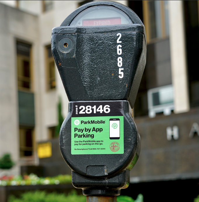 a parking meter with a green label