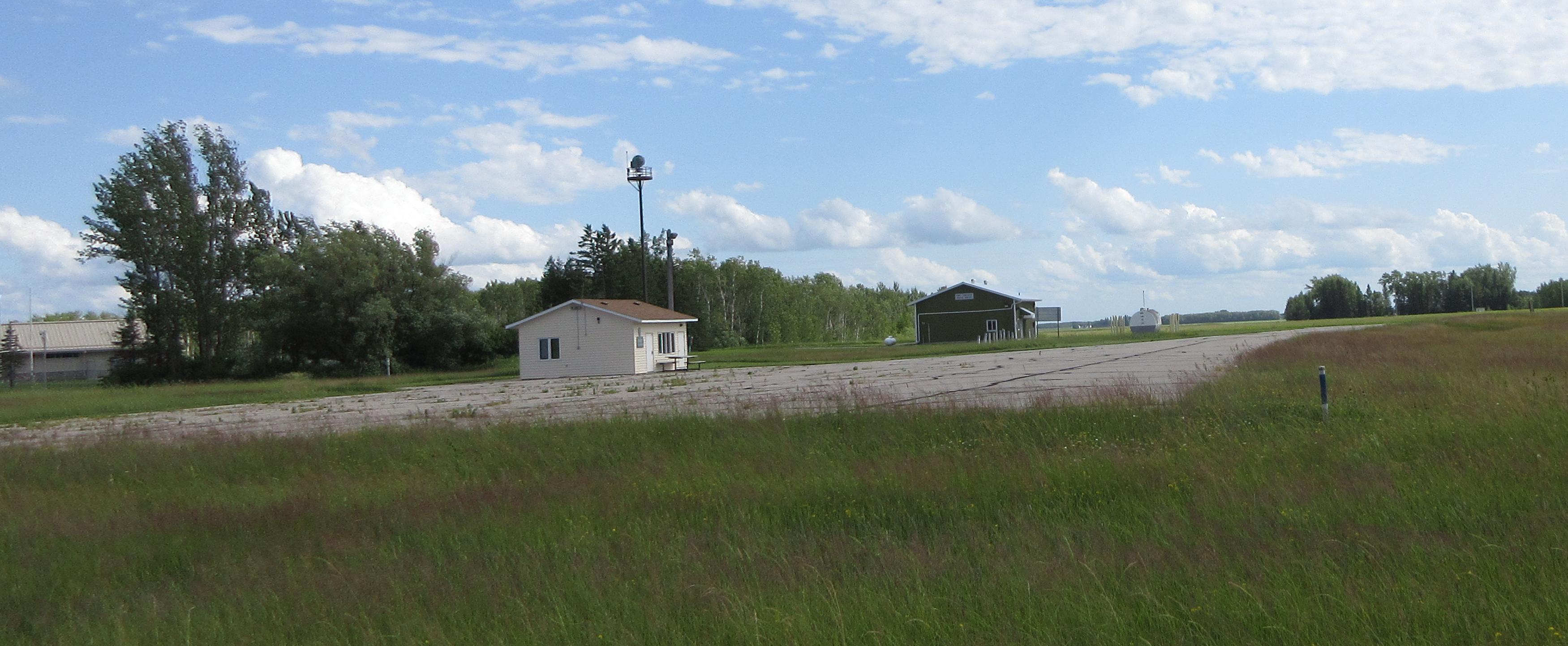 a house and a building in a field