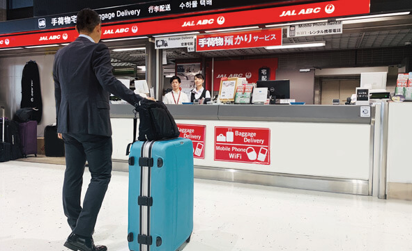 a man in a suit pulling a suitcase