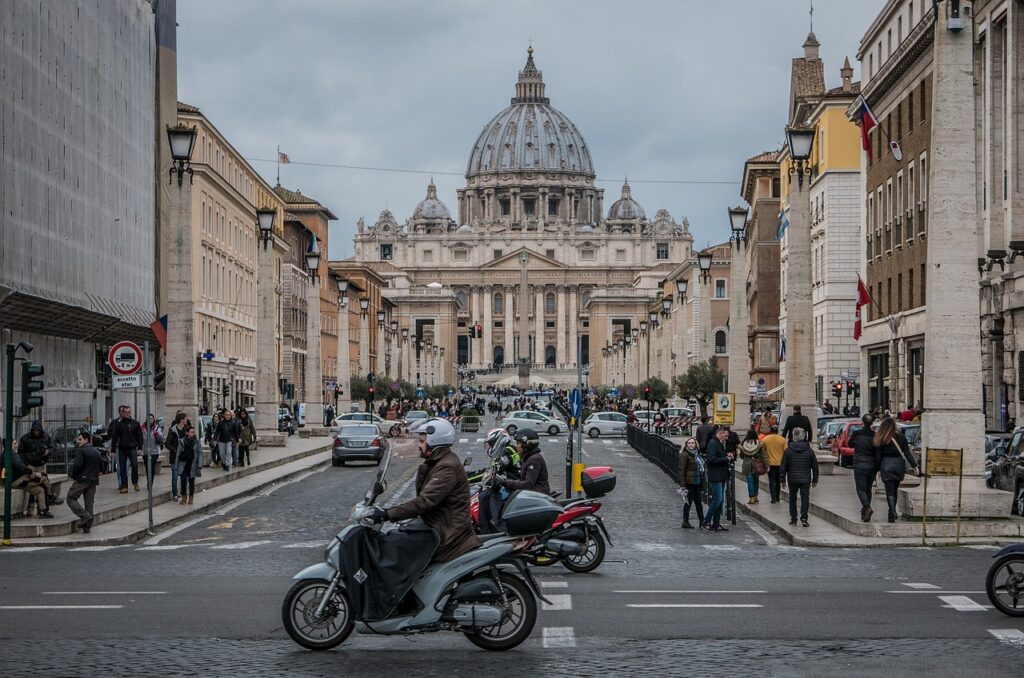 a man riding a scooter on a street in a city