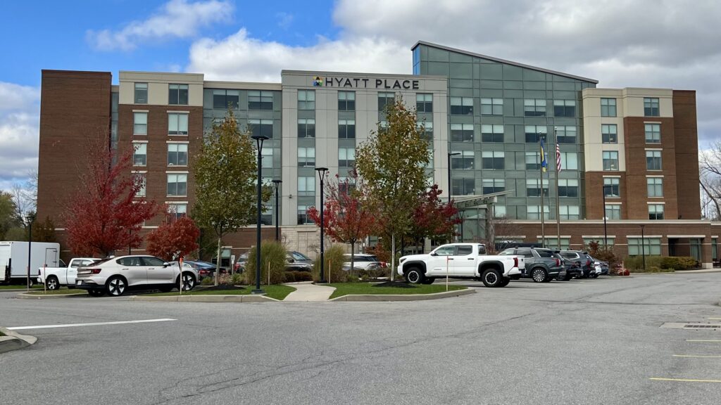 a parking lot with cars and a building