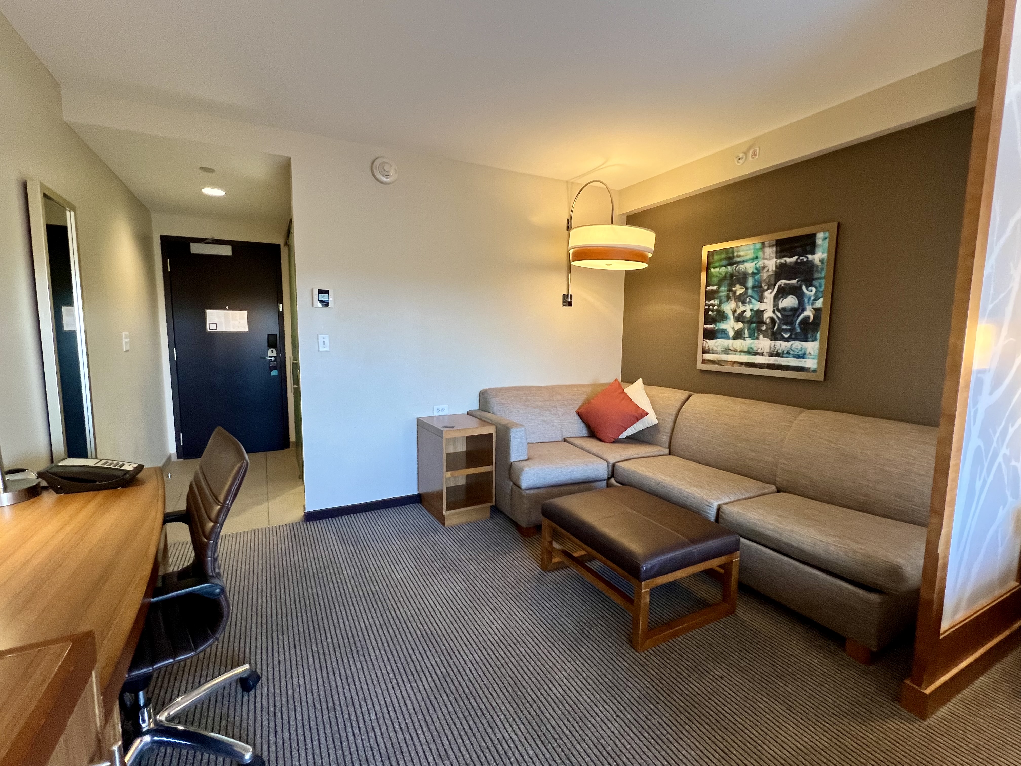 a living room with a couch and a desk