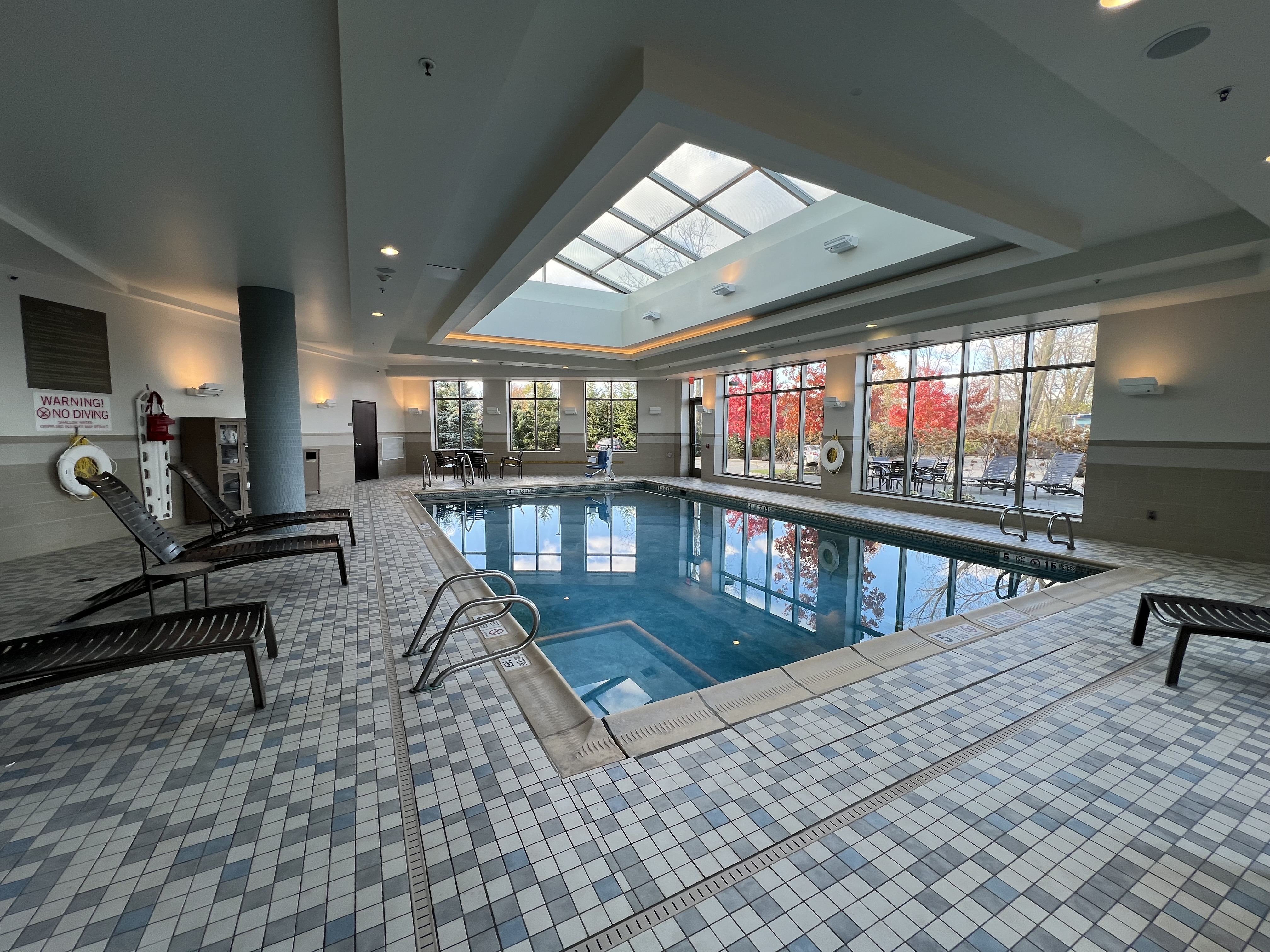 a indoor pool with a large skylight