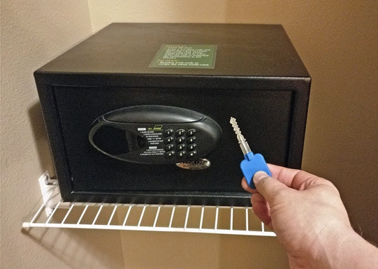 a hand holding a key to a safe