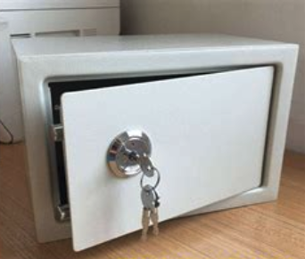 a small white box with a key in it