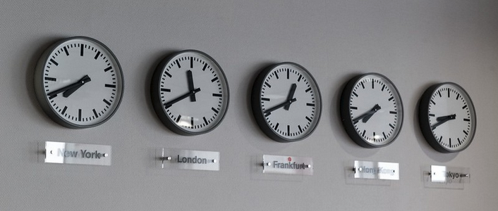 a row of clocks on a wall