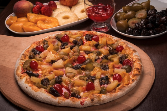 a pizza with fruit on a wooden board