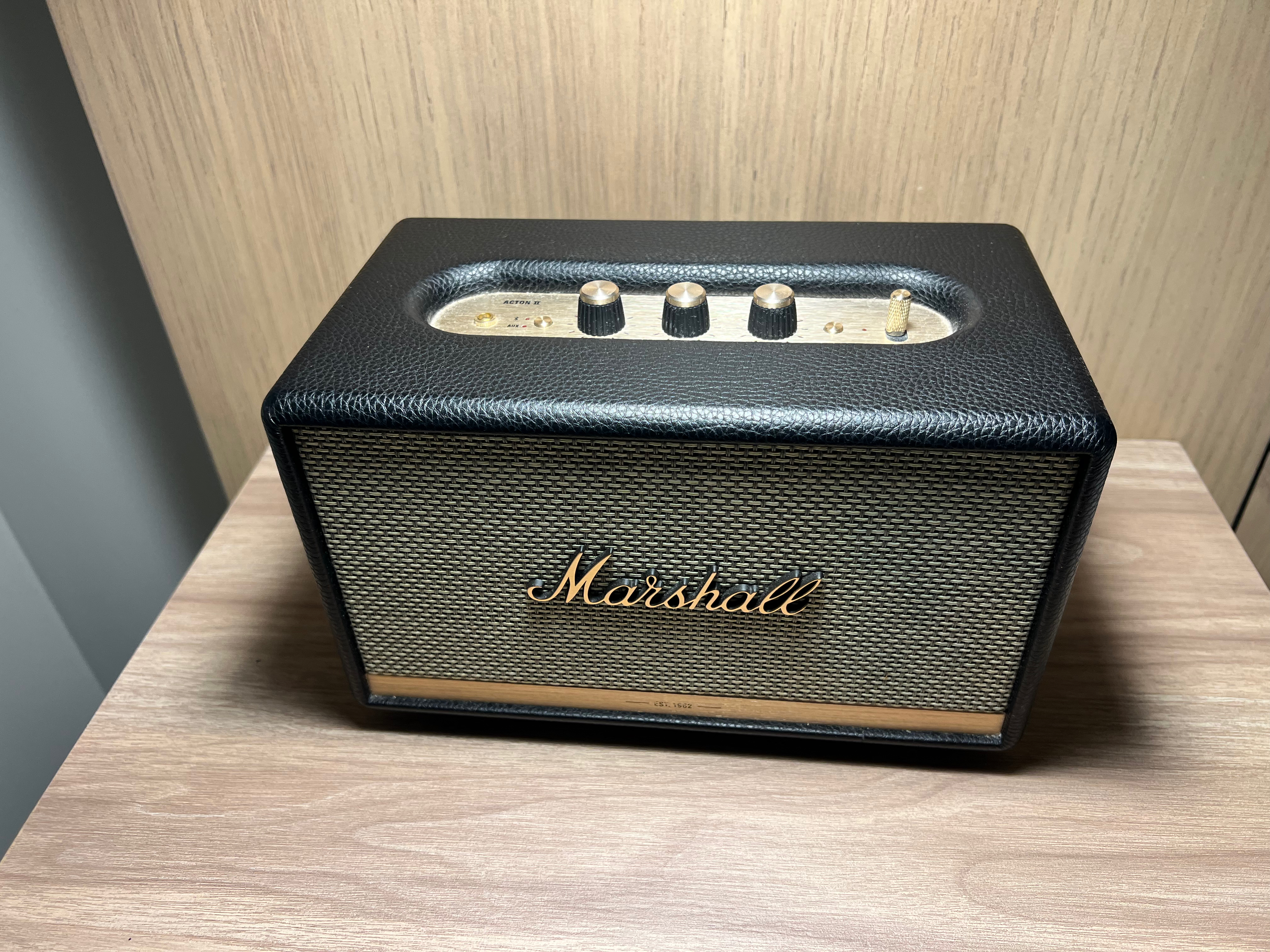 a rectangular black speaker with buttons