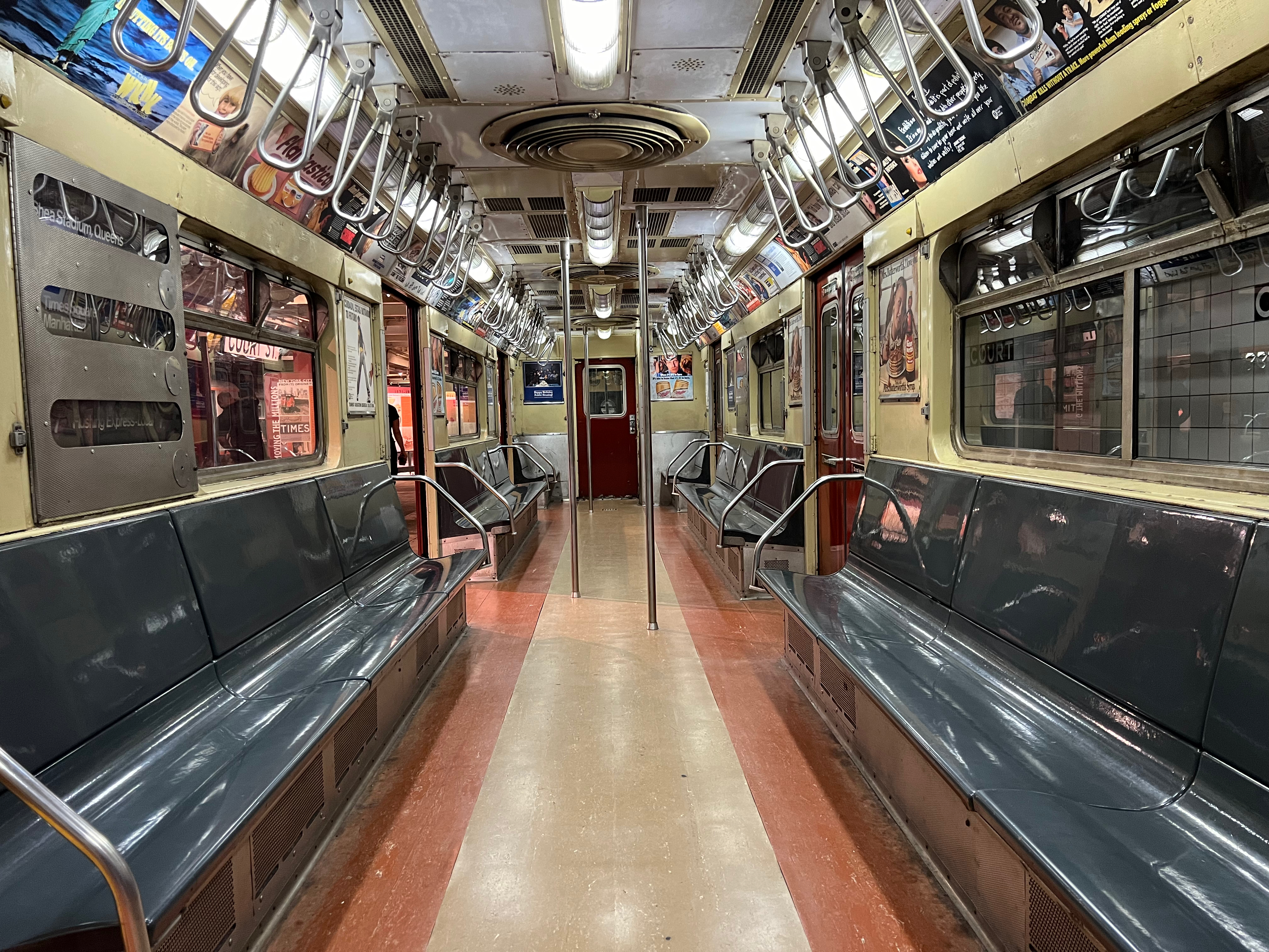 a train with seats and a pole