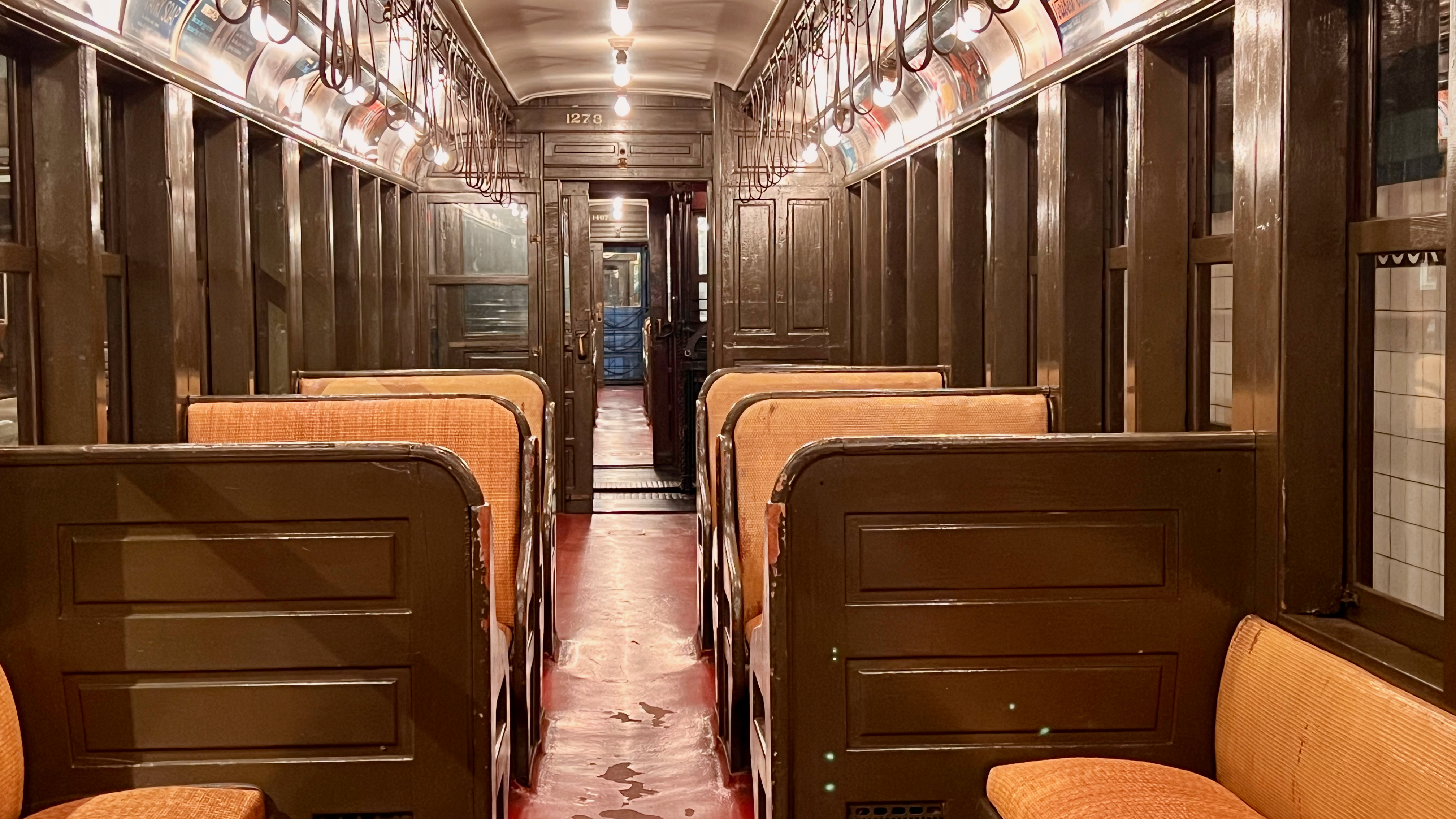 inside a train car with seats and lights