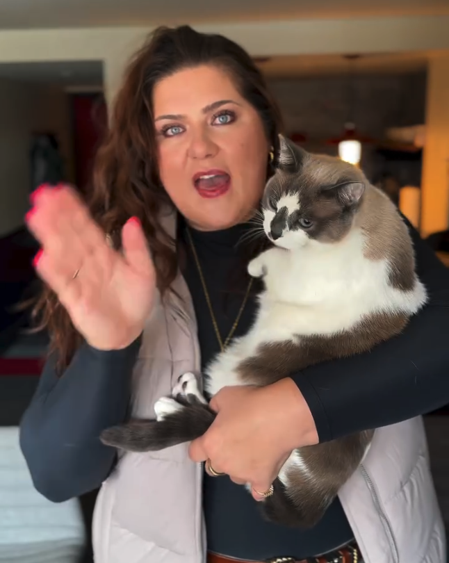 a woman holding a cat