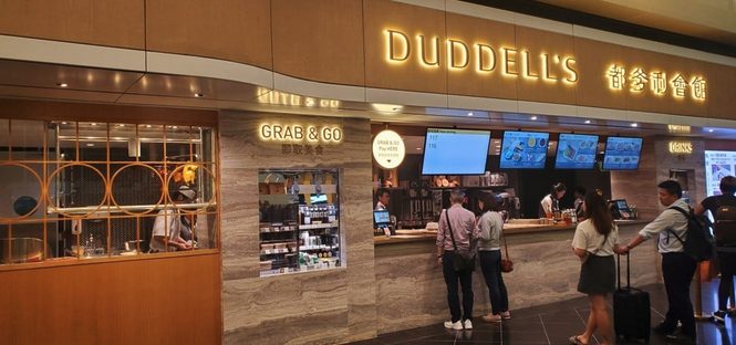 people standing in front of a coffee shop