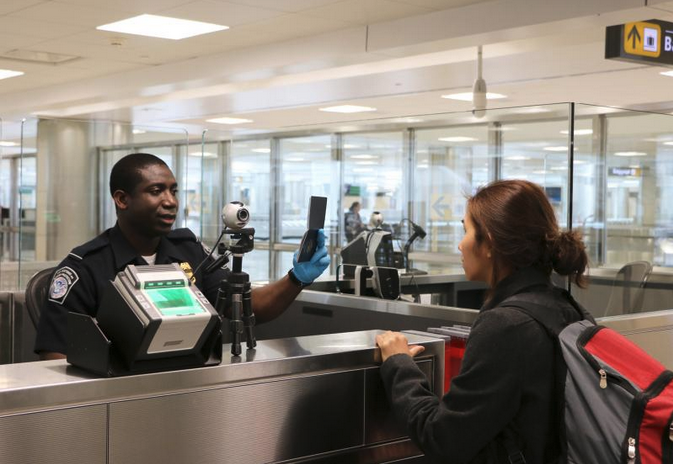 a man standing at a counter with a woman behind him