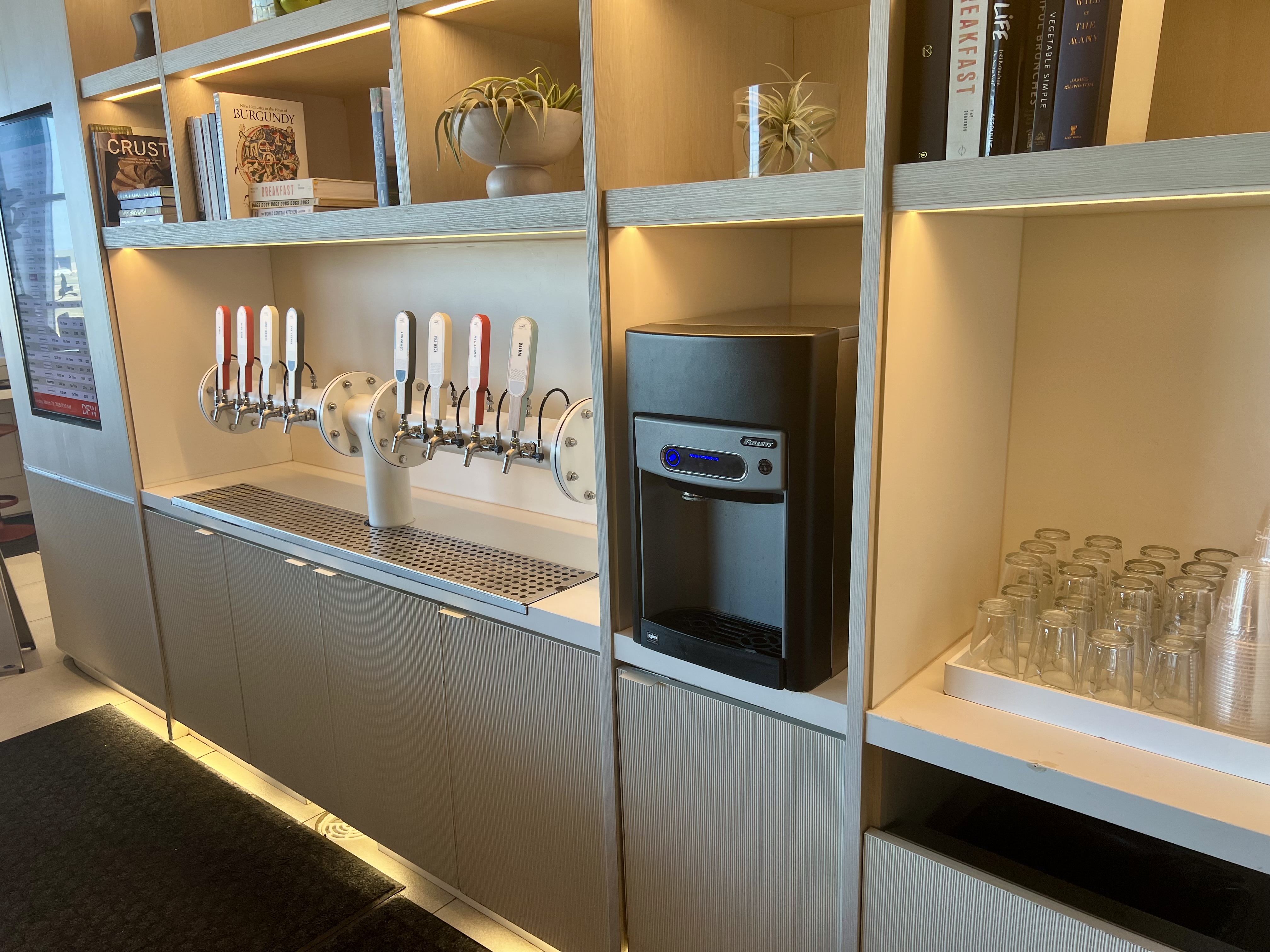 a row of white shelves with a black machine and several white objects