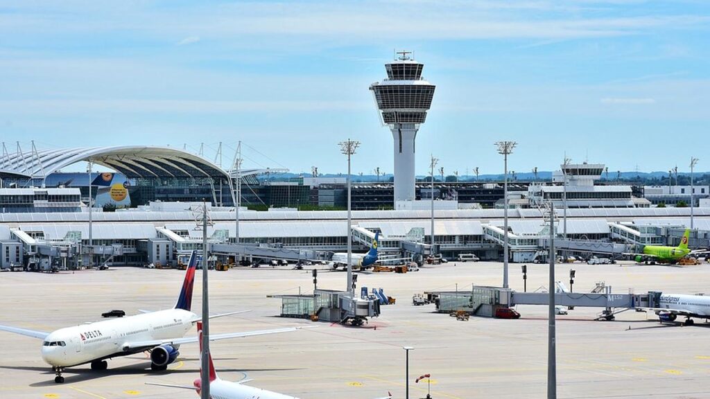 an airport with airplanes and control tower