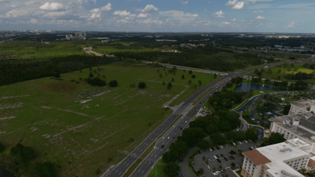 a road with cars and trees in the background