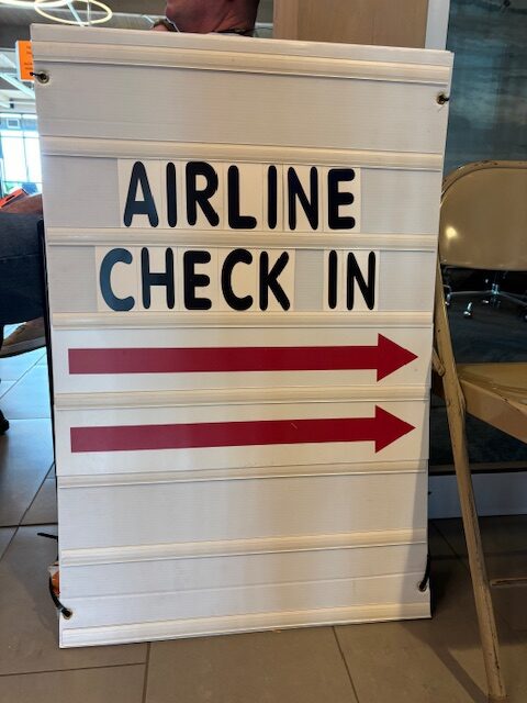 a sign with red arrows and black text