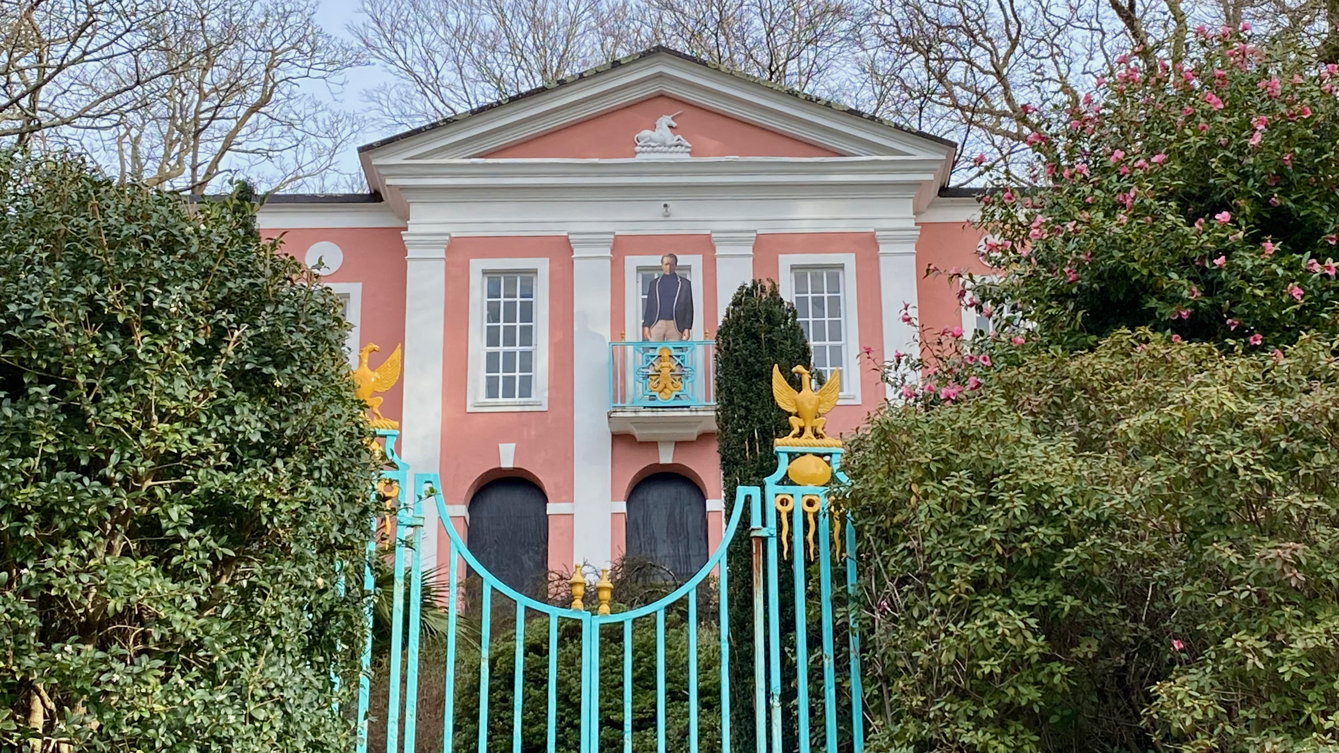 a gated entrance to a pink building