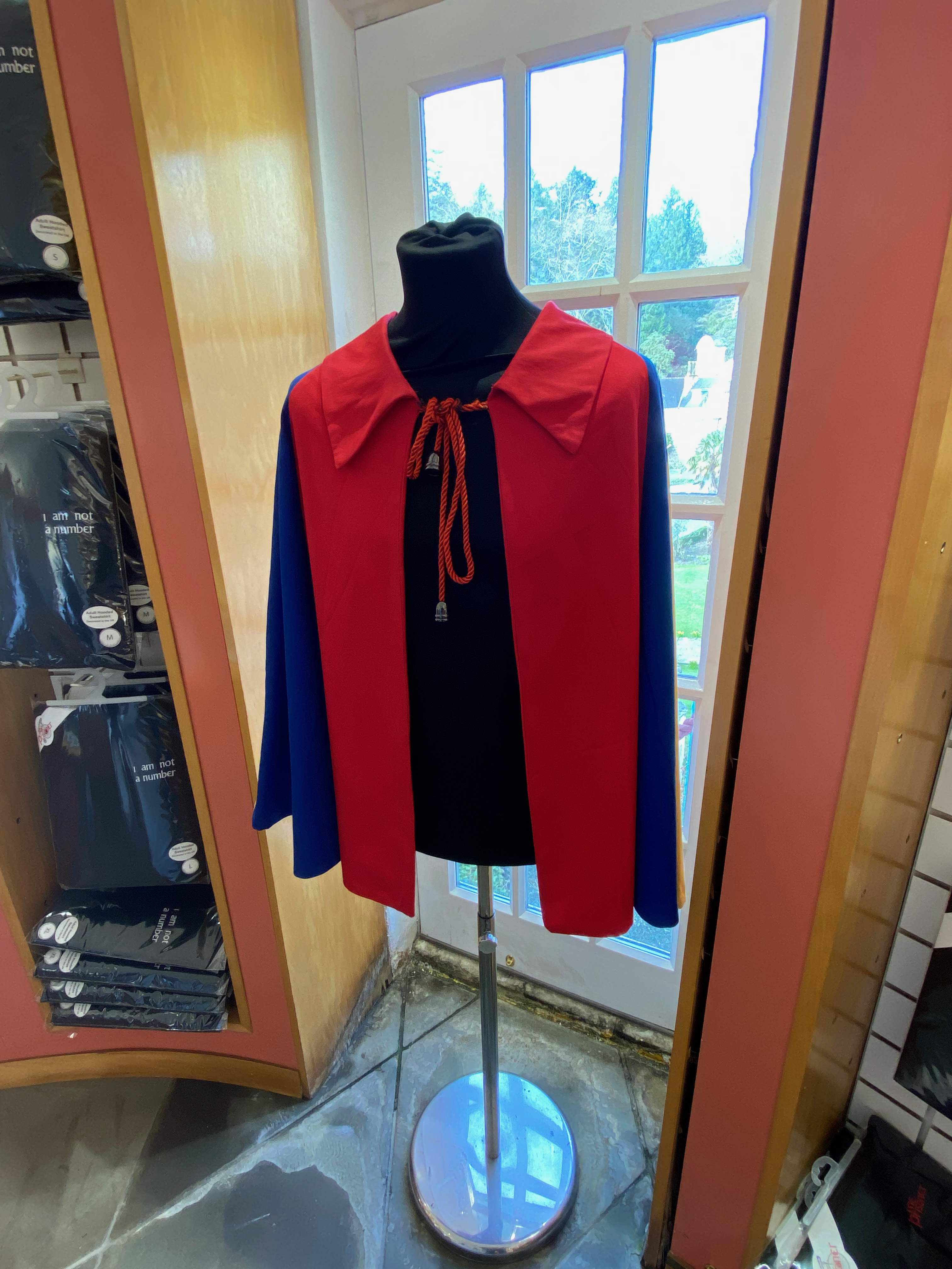 a red and blue cape on a mannequin