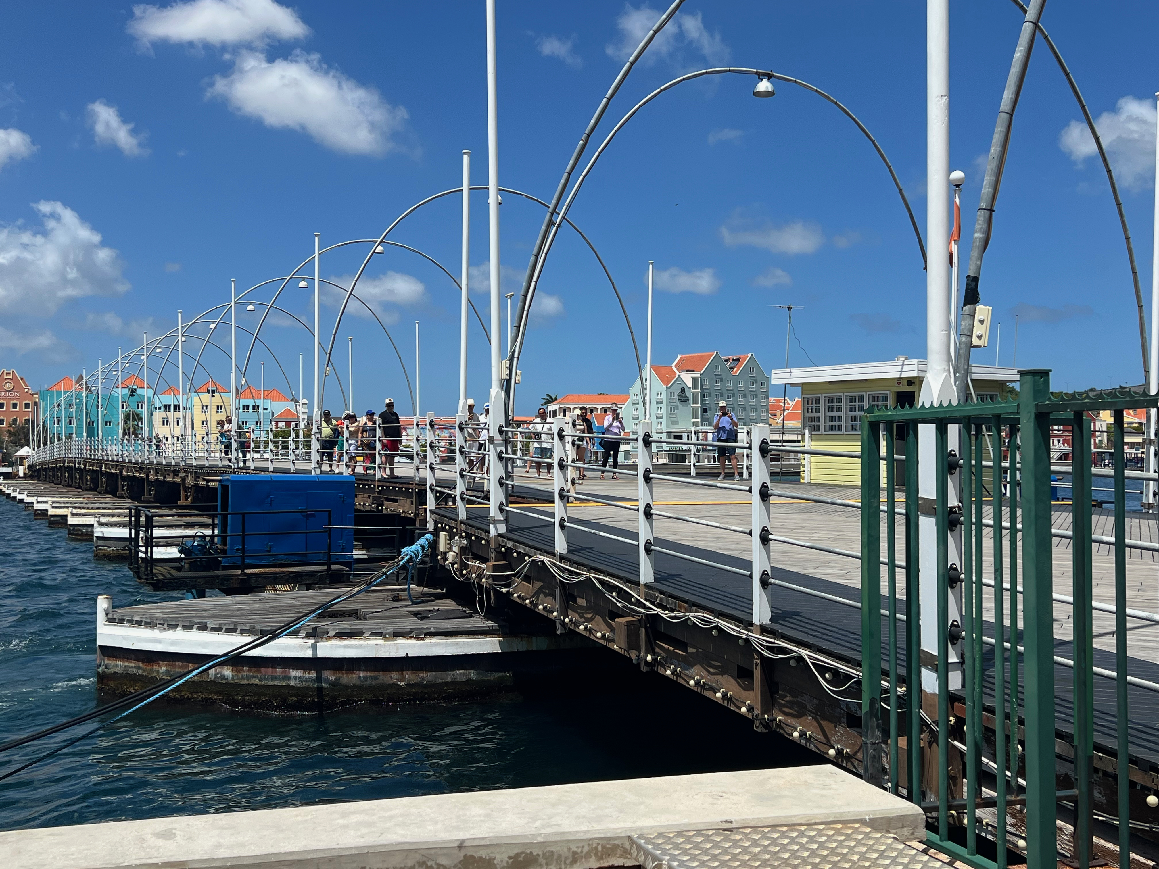 a bridge over water with people walking on it