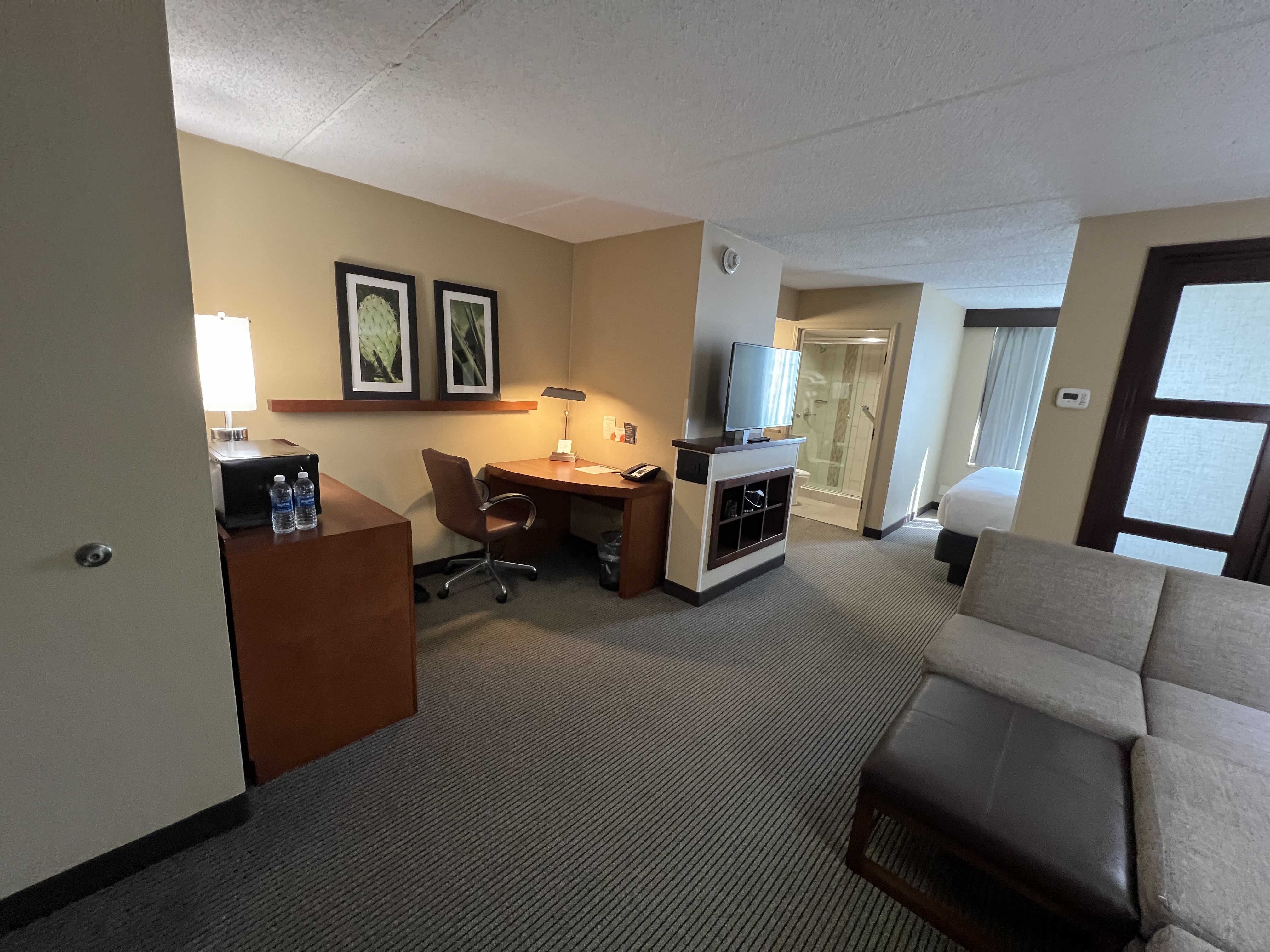 a room with a desk and a television