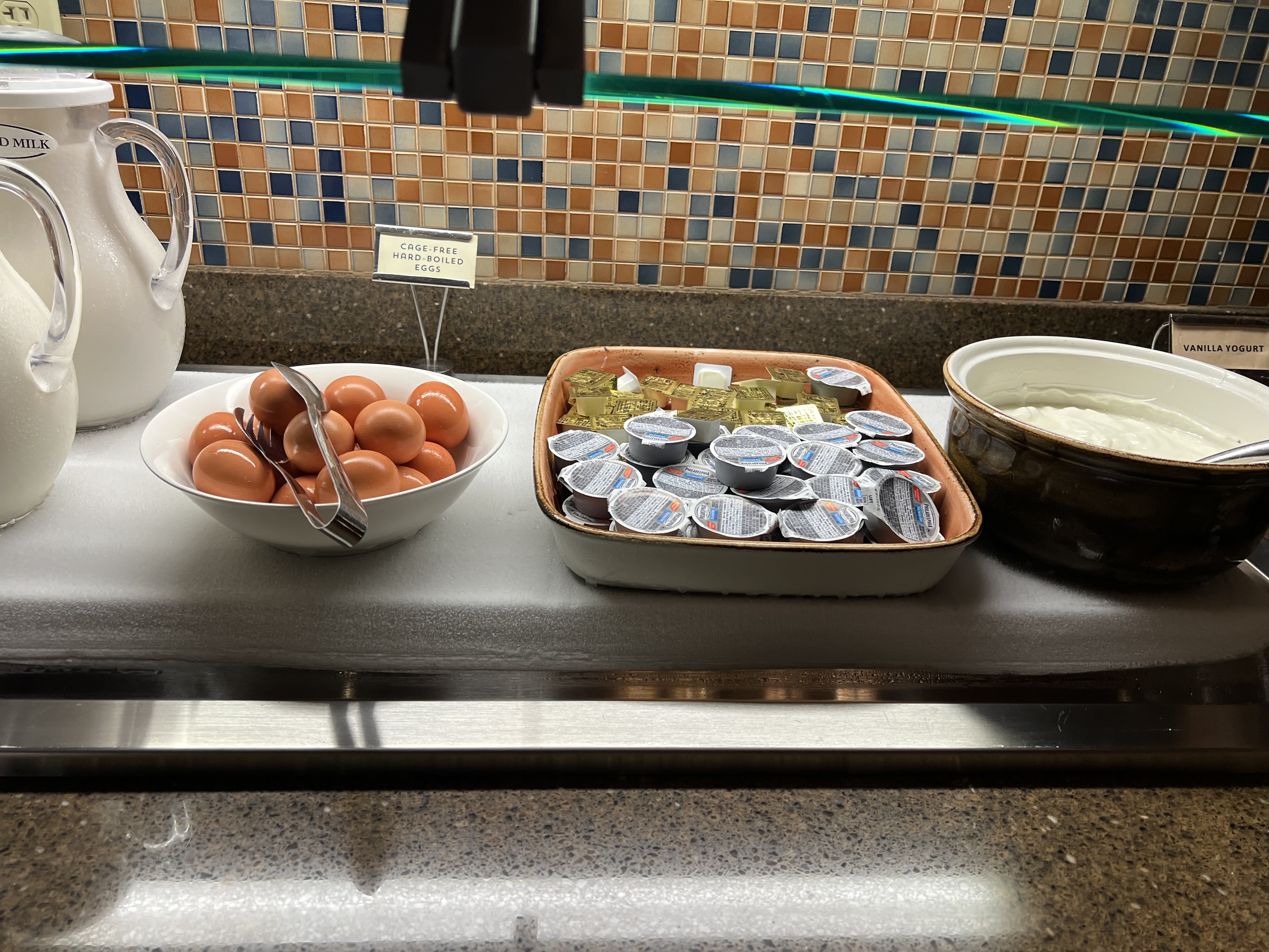 a bowl of eggs and yogurt in bowls on a counter