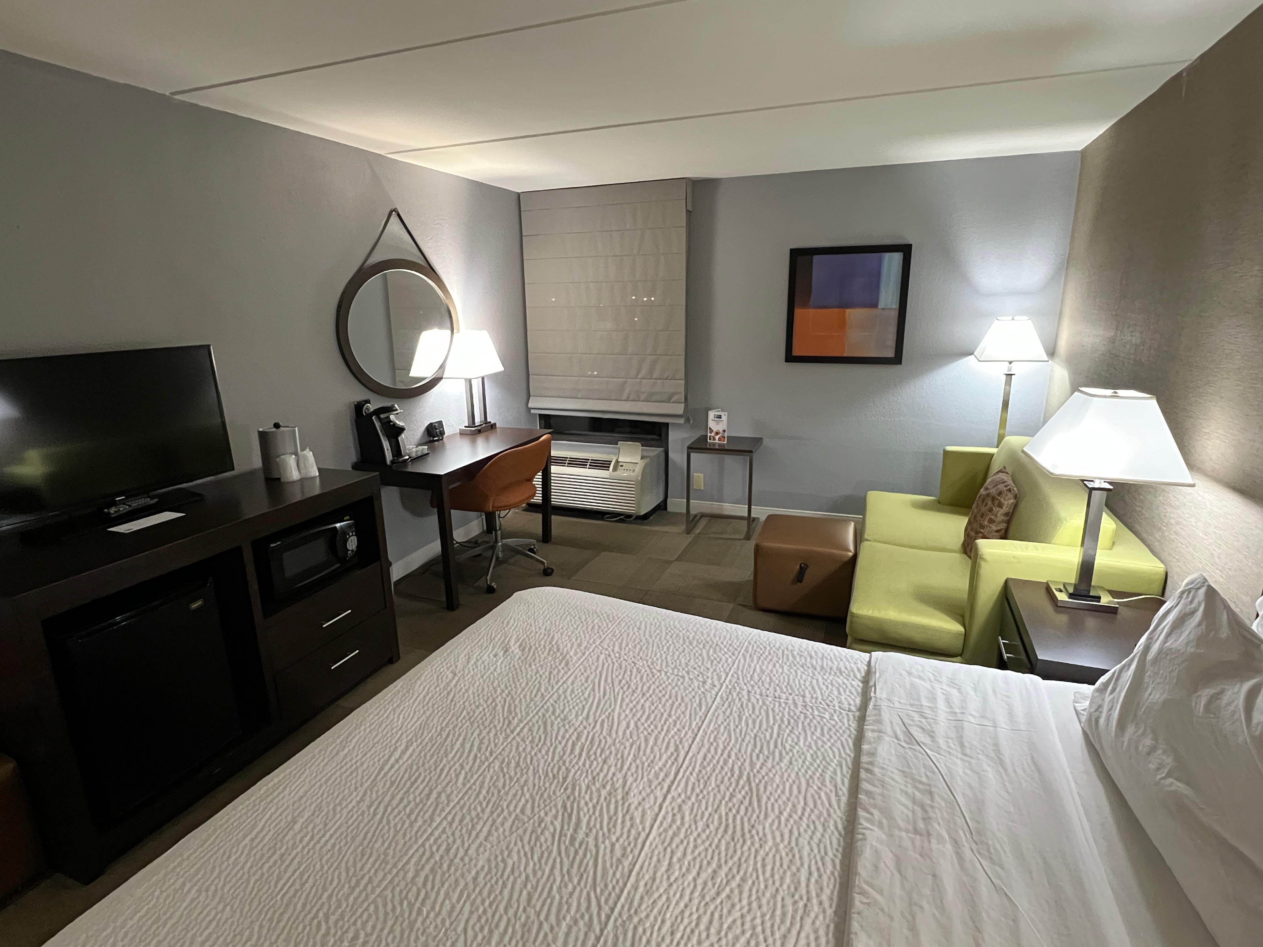 a room with a bed and a television