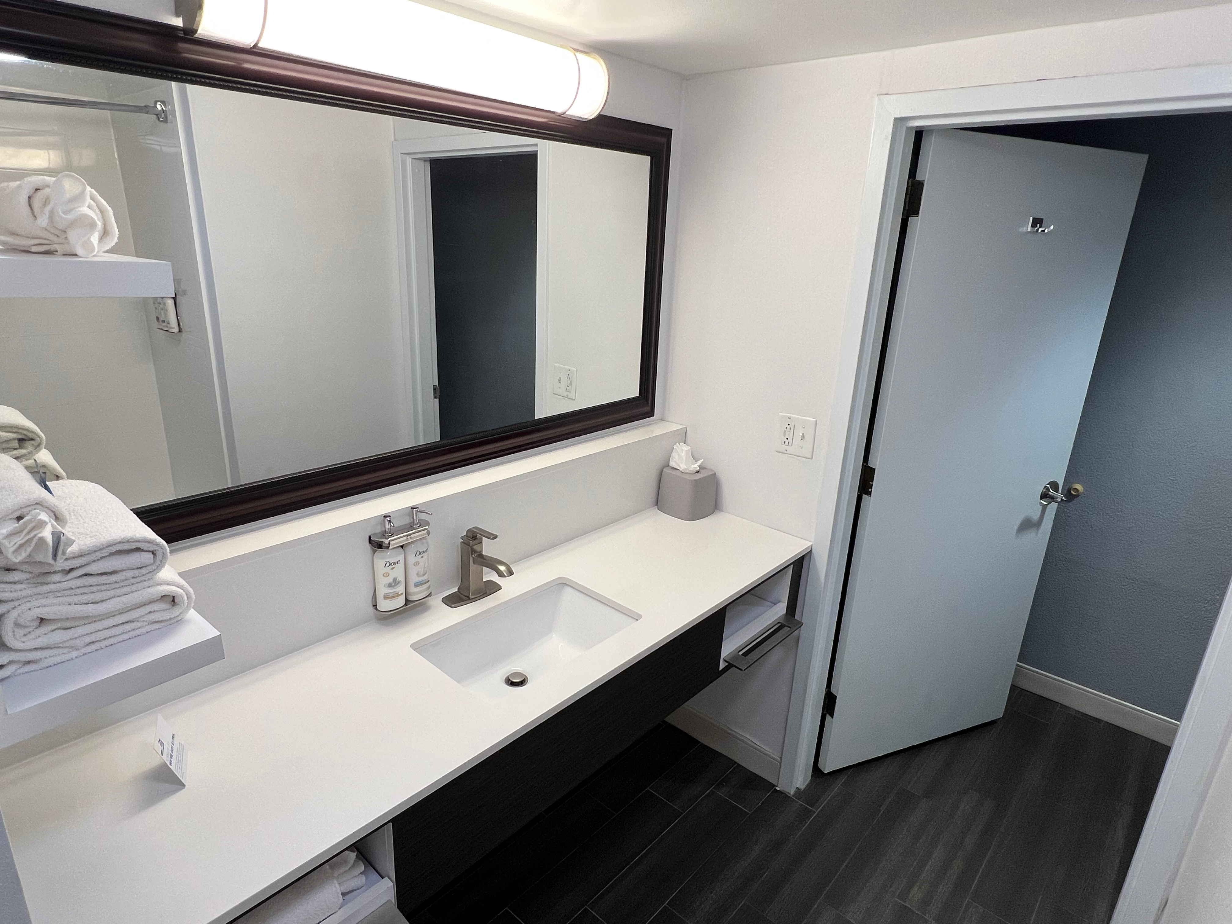 a bathroom with a mirror and sink