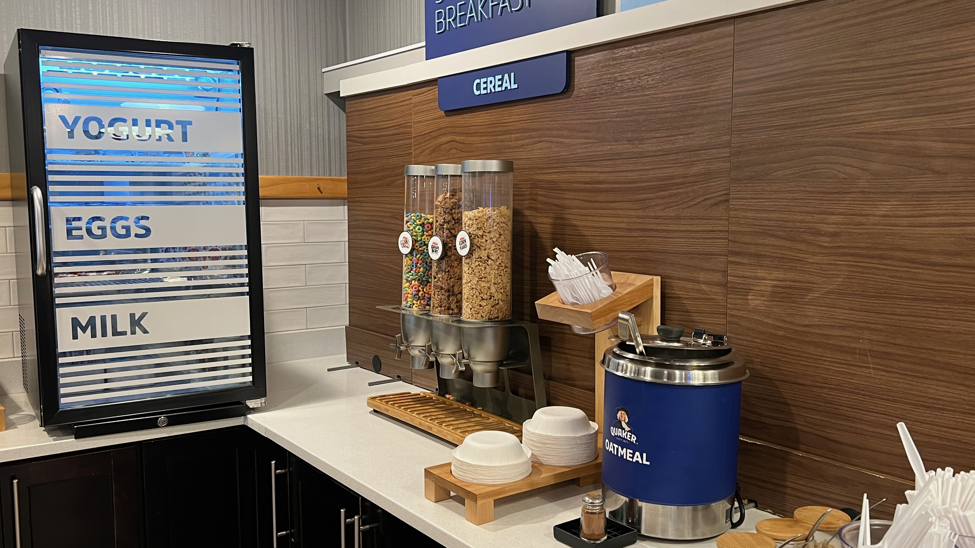 a breakfast buffet with cereals and a blue container