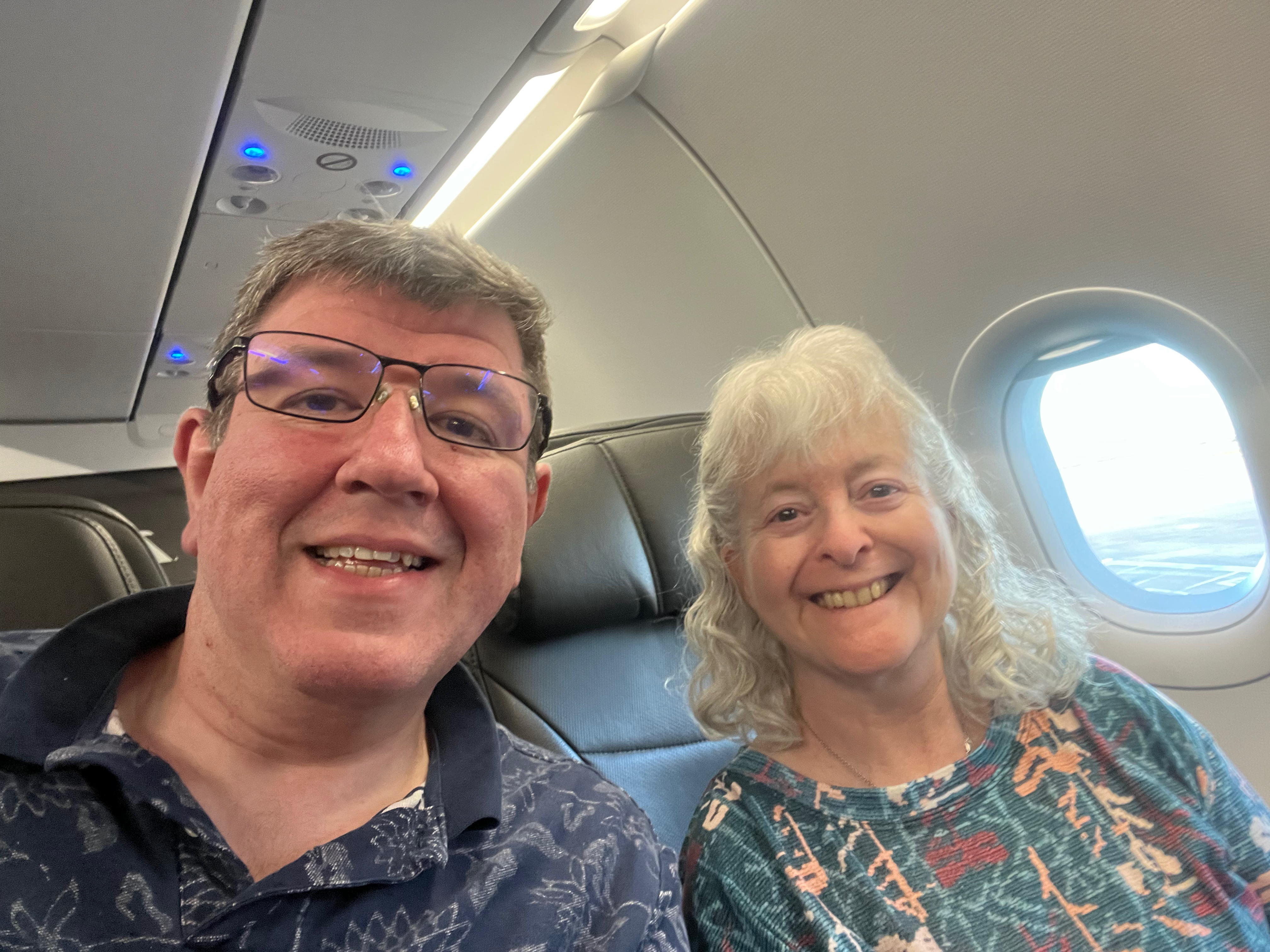 a man and woman sitting in a plane