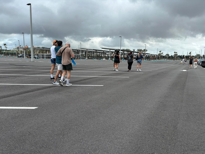 a group of people walking in a parking lot