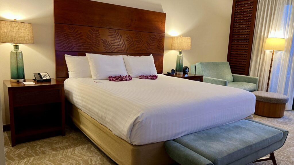 a bed with white sheets and flowers on it