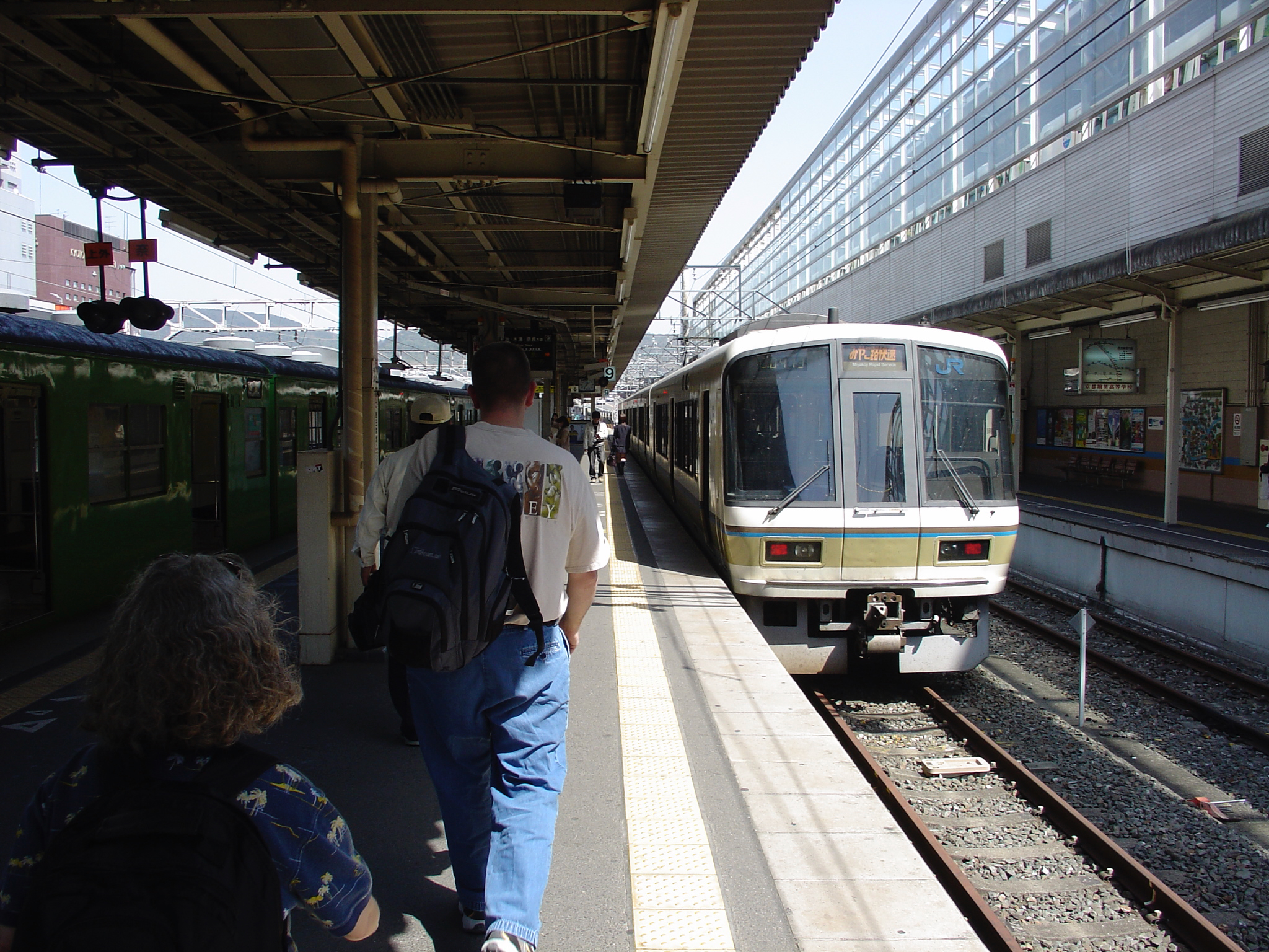 a man walking next to a train