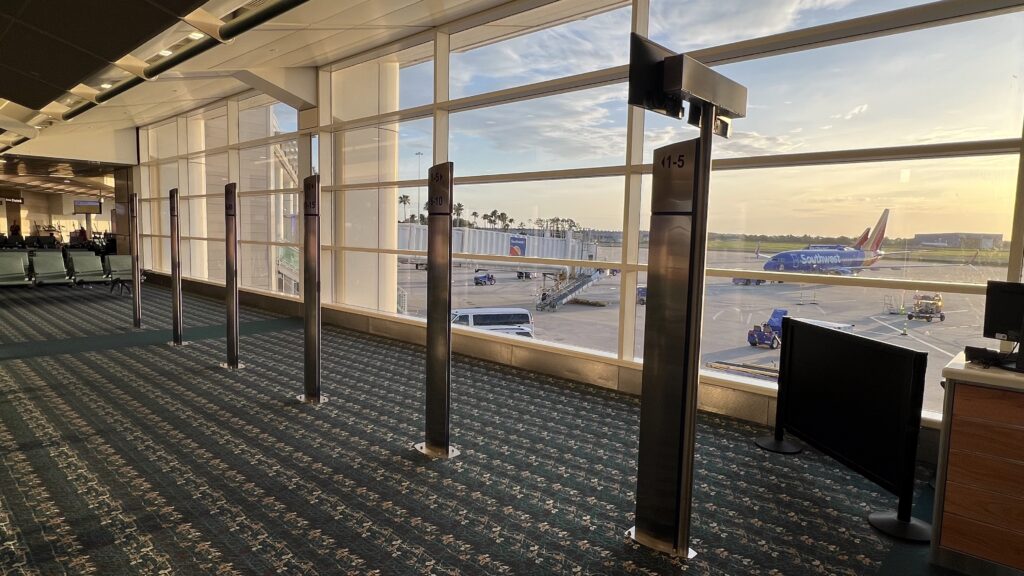 Southwest Airlines plane at sunrise seen through airport window with empty gate area