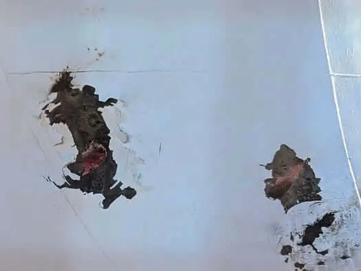 a white wall with black spots