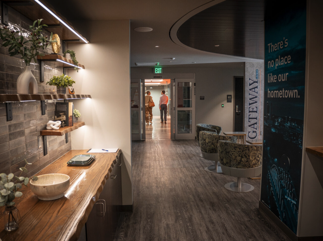 a hallway with a couple of people walking in the background