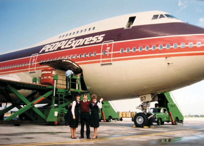 a group of people standing in front of an airplane