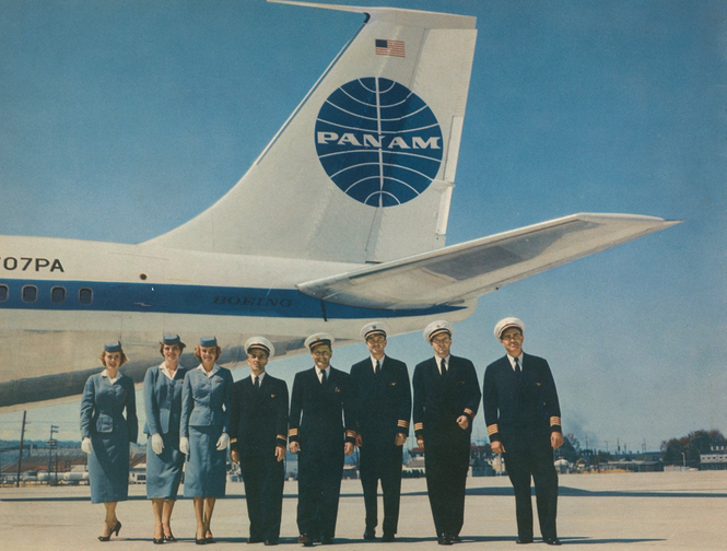 a group of people standing in front of an airplane