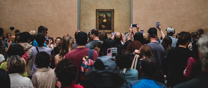 a group of people looking at a painting