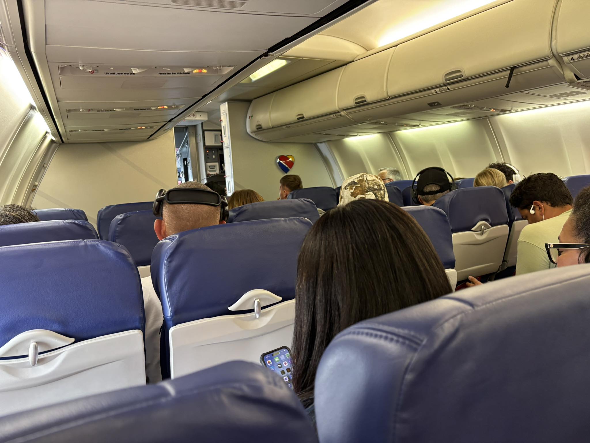 a group of people sitting in an airplane