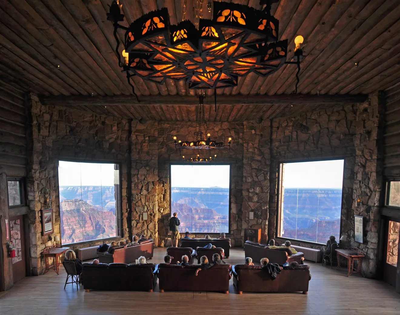 a room with a large chandelier and couches