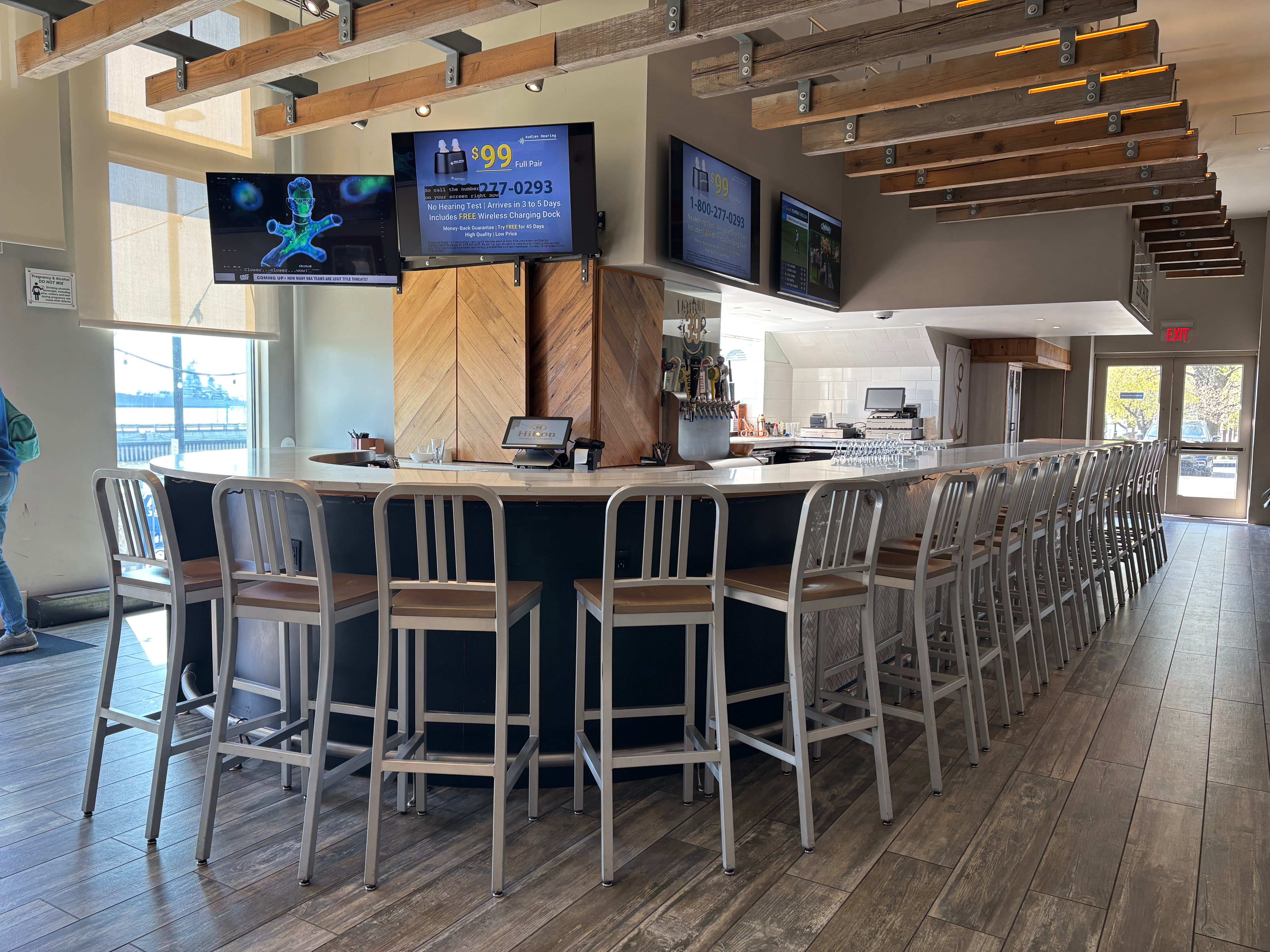 a bar with chairs and a television set