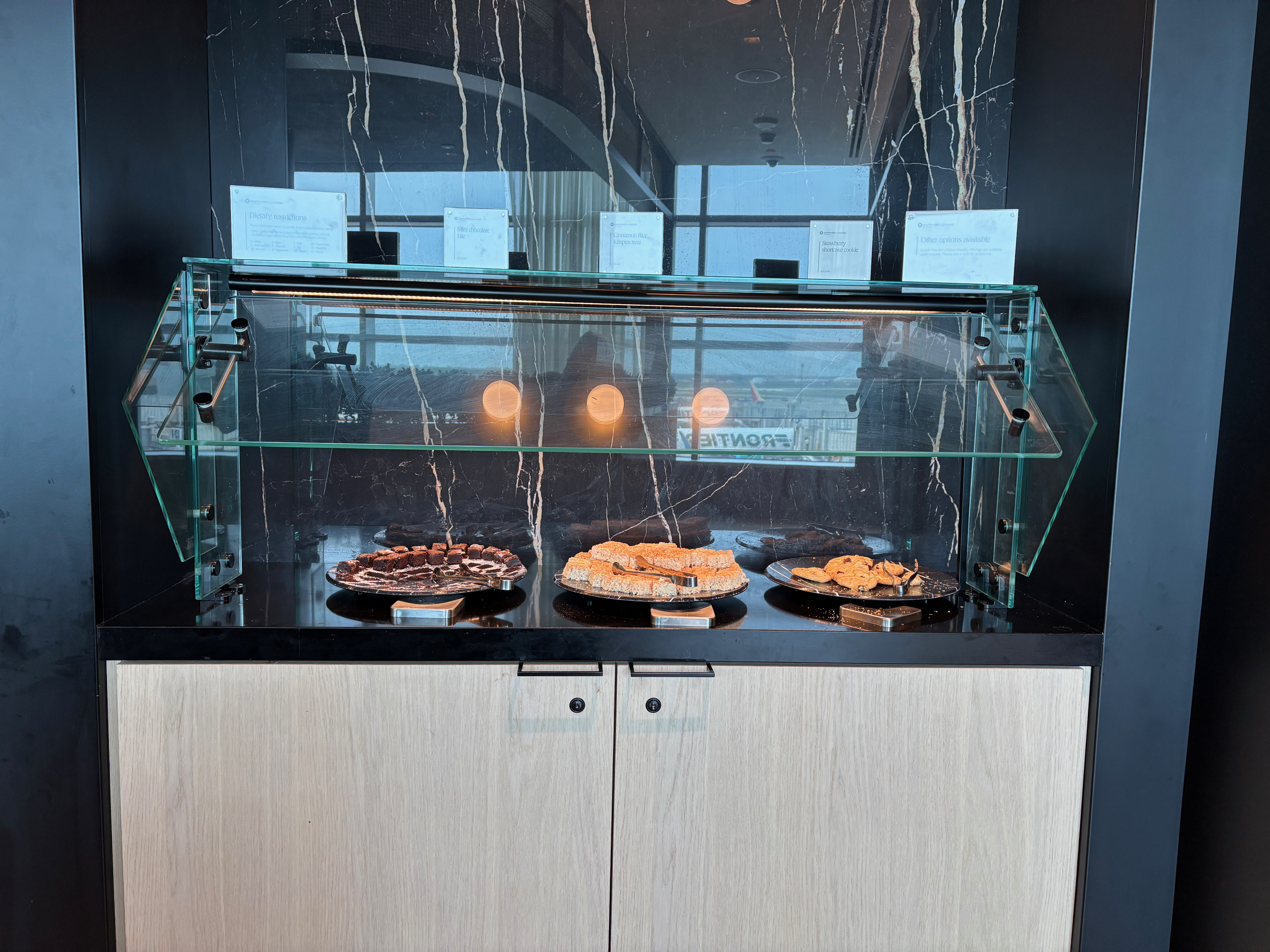 food on plates in a glass case
