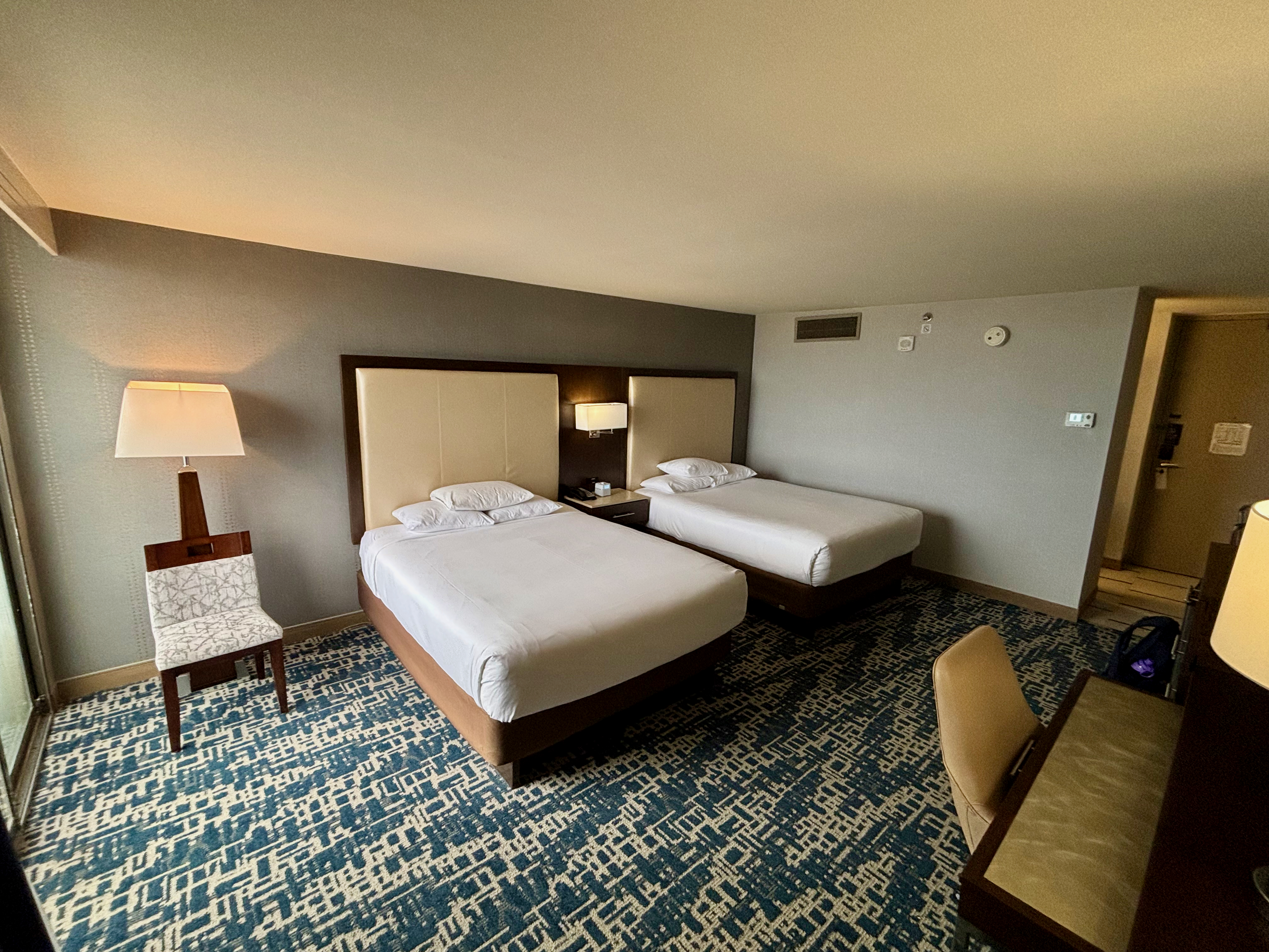 a room with two beds and a table