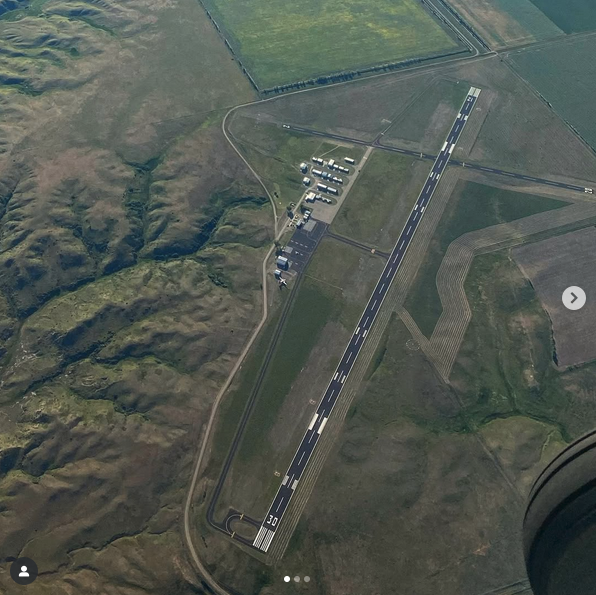 an aerial view of a runway and land