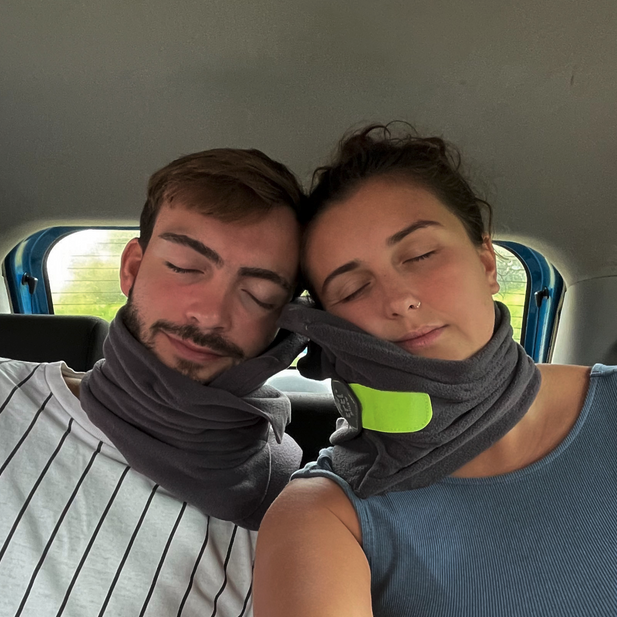 a man and woman taking a selfie in a car