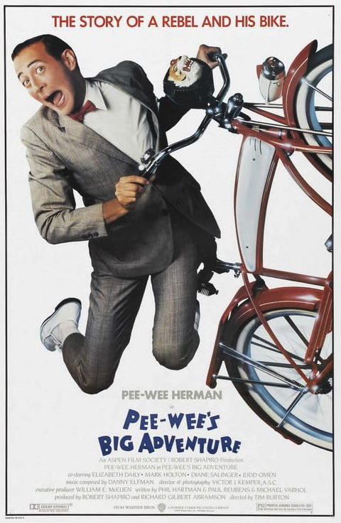 a man in a suit and bow tie holding a bicycle