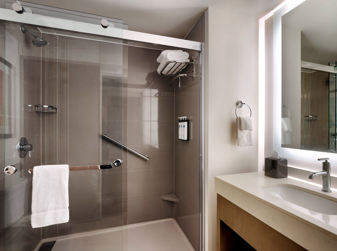 a bathroom with a glass shower door