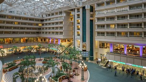 a large building with many floors and palm trees
